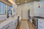 Featuring farmhouse sink and high-end finishes